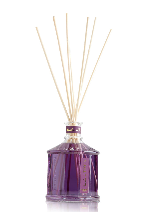 Glass bottle with purple color Tuscan berries home fragrance liquid and reed sticks.