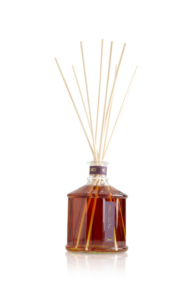 Glass bottle with brown color grapewood home fragrance liquid and reed sticks.