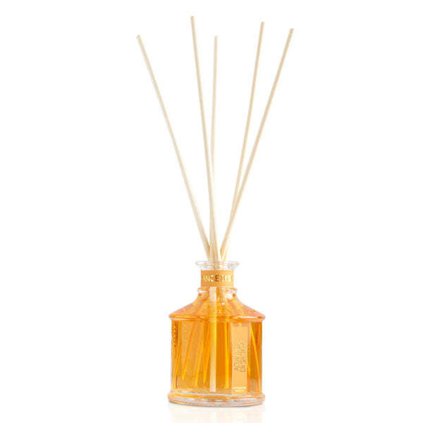  Glass bottle with light orange Sicily citrus home fragrance liquid and reed sticks.
