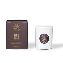 Brown color Opium smoke pack box kept along side the white candle container.