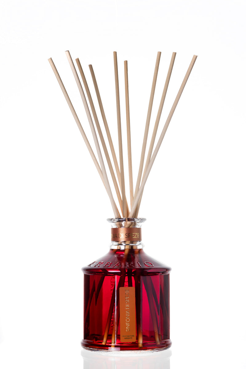  Glass bottle with red color symphony of spices home fragrance liquid and reed sticks.